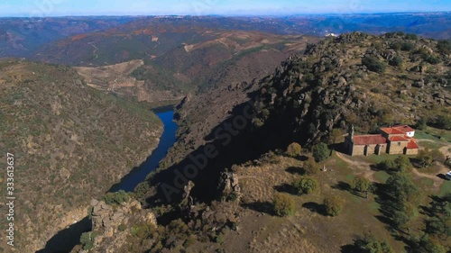 Aerial drone view in valley and Douro River with little church in Arribes del Duero . Salamanca, Spain. photo