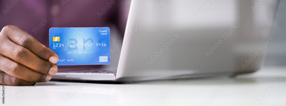 Man Sitting With Laptop And Credit Card Man Sitting With Laptop And Credit Card
