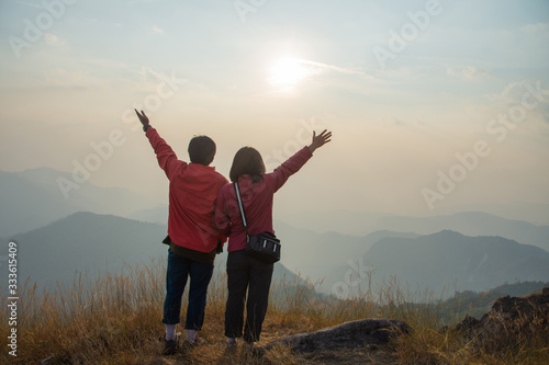 rear of happy couple love stand on top mountain looking view at Mulayit Taung, Myanmar. soft focus and vintage tone.