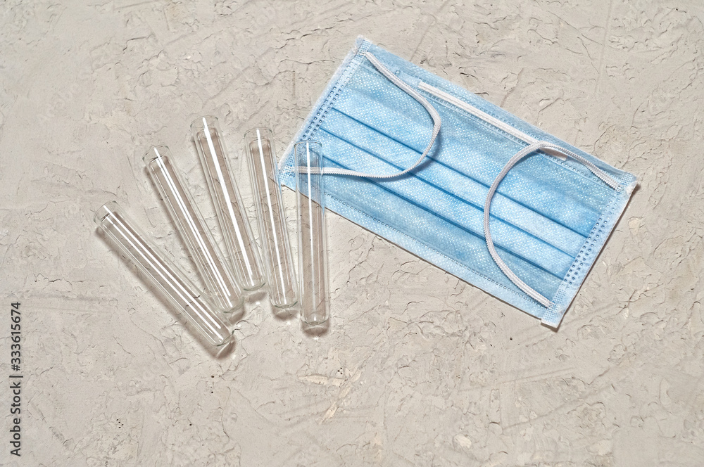 medical mask, gloves, test tubes on a textured background medical mask, gloves, test tubes on a textured background