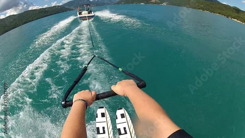 POV view of waterskiing. Water ski summer sports action camera, blue water lake.