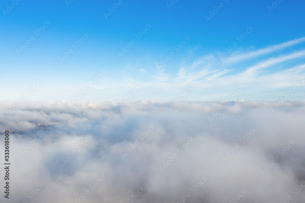 Aerial view of cloudscape layers of soft fluffy clouds over the city on a summer sunny day. Aerial view of cloudscape layers of soft fluffy clouds over the city on a summer sunny day.