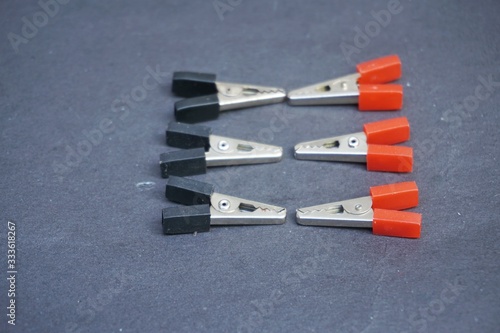 A crocodile clip (also alligator clip) is a sprung metal clip with long, serrated jaws which is used for creating a temporary electrical connection