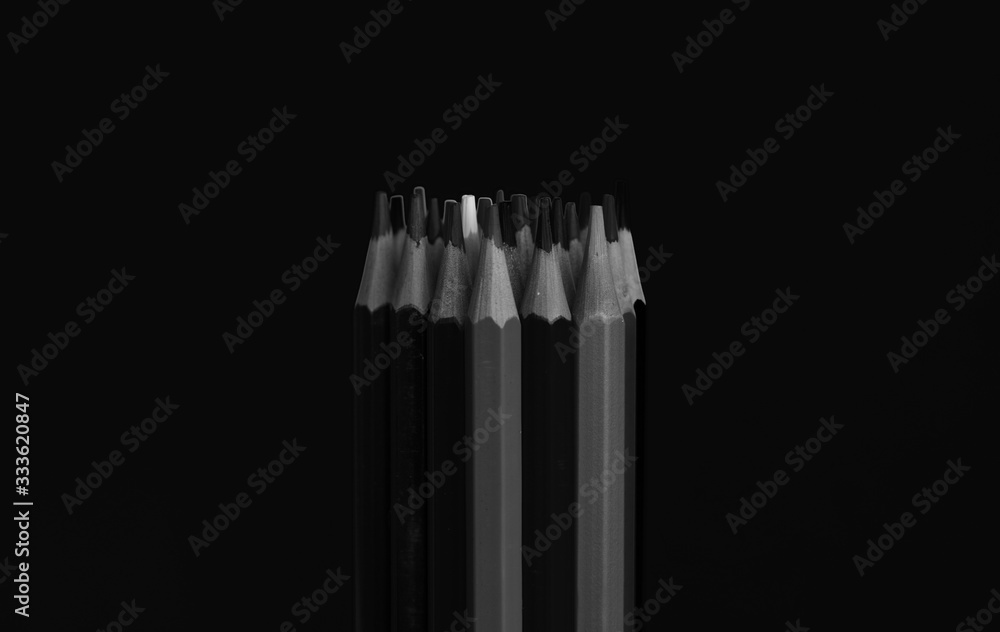 Set of black and white pencils and the white color predominates Set of black and white pencils and the white color predominates