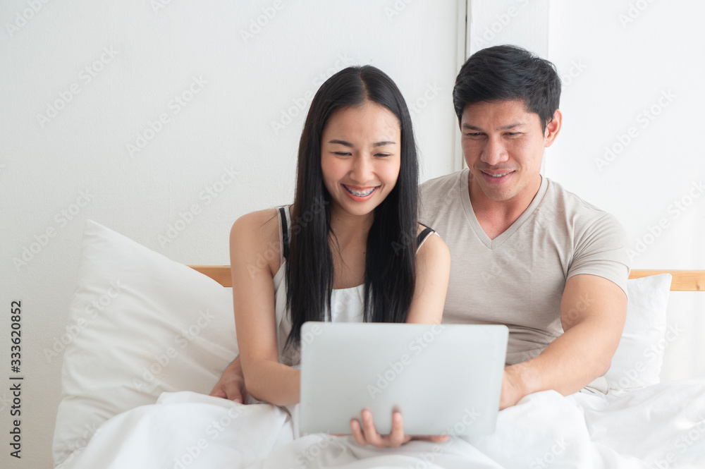 Happy couples enjoying working at home during corona virus is spreading throughout the world. stay at hame and stay save concept. Happy couples enjoying working at home during corona virus is spreading throughout the world. stay at hame and stay save concept.