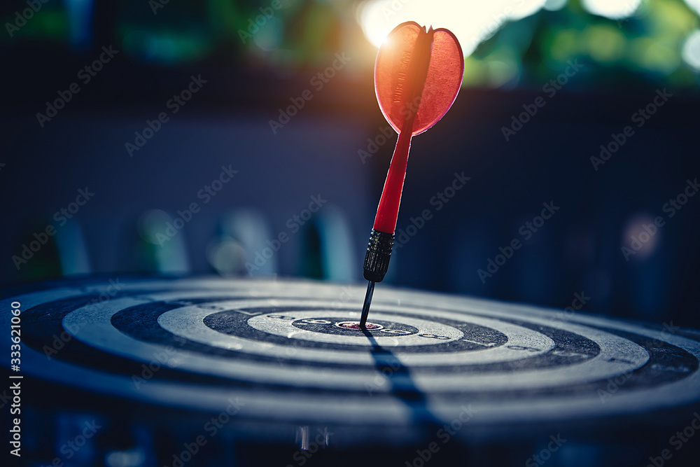 Bullseye(bull's-eye) or dart board has dart arrow hitting the center of a shooting target for business targeting and good success. Bullseye(bull's-eye) or dart board has dart arrow hitting the center of a shooting target for business targeting and good success.