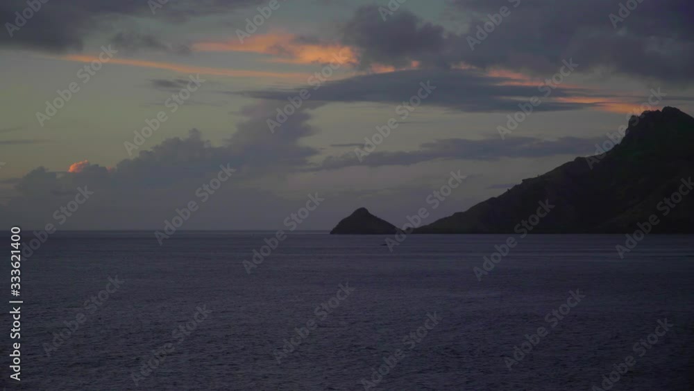 The beautiful sunset sky over the waters and mountains of Fiji - wide shot The beautiful sunset sky over the waters and mountains of Fiji - wide shot