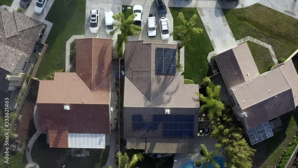 Rising birds eye aerial of house with solar panels on roof. Renewable energy on residential home Rising birds eye aerial of house with solar panels on roof. Renewable energy on residential home