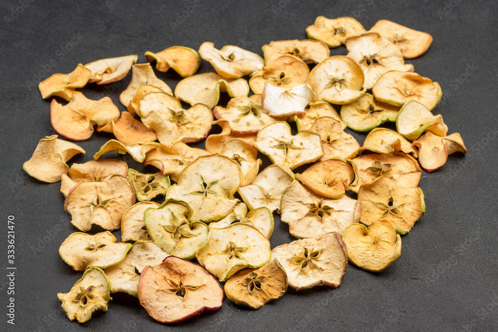 Slices of dried apples on black background. Healthy Diet Snack. . Slices of dried apples on black background. Healthy Diet Snack. .