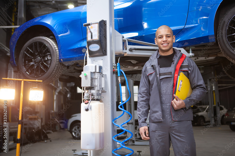 custom made wallpaper toronto digitalCheerful African man smiling to the camera enjoying repairing cars at his workshop