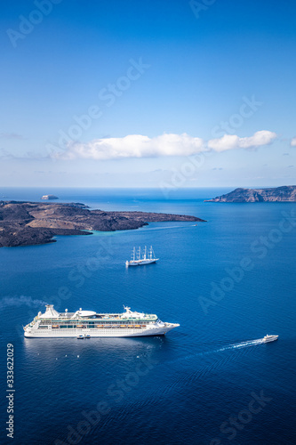 Beautiful landscape with sea view. Cruise liner at the sea near the islands. Santorini island, Greece.