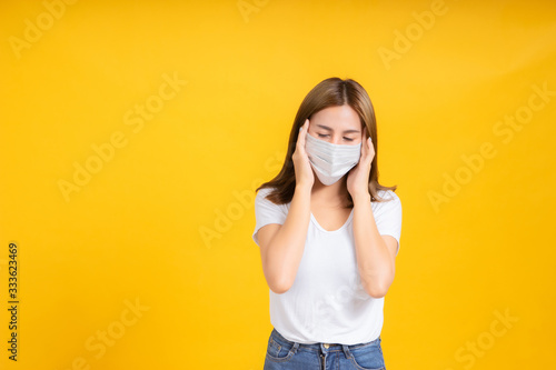 Coronavirus covid 19 mask protects filter of Young asian woman cough infection her is sick and cold unhealthy on yellow background, illness safety with mask protective concept