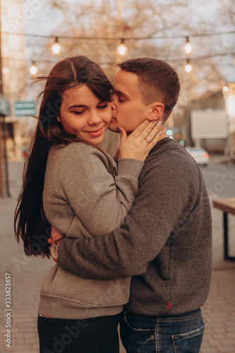 a young couple embraces in the street