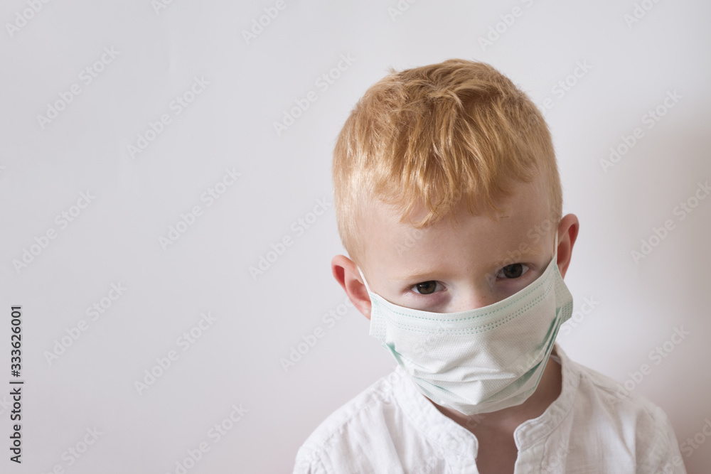 Little boy in medical mask on white background with copy space.