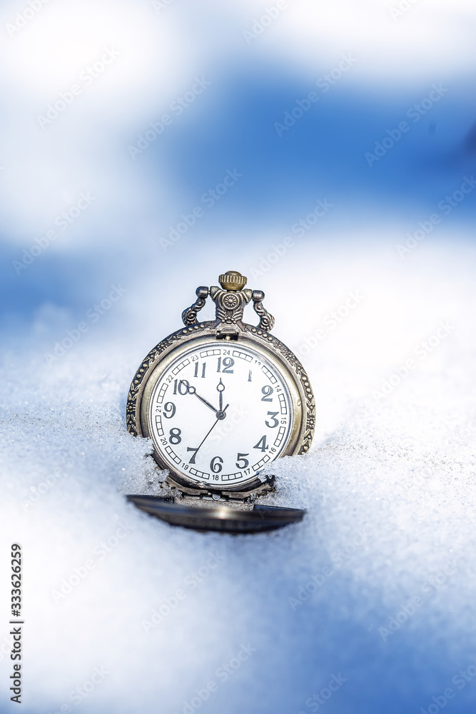 Historic watch on winter background.