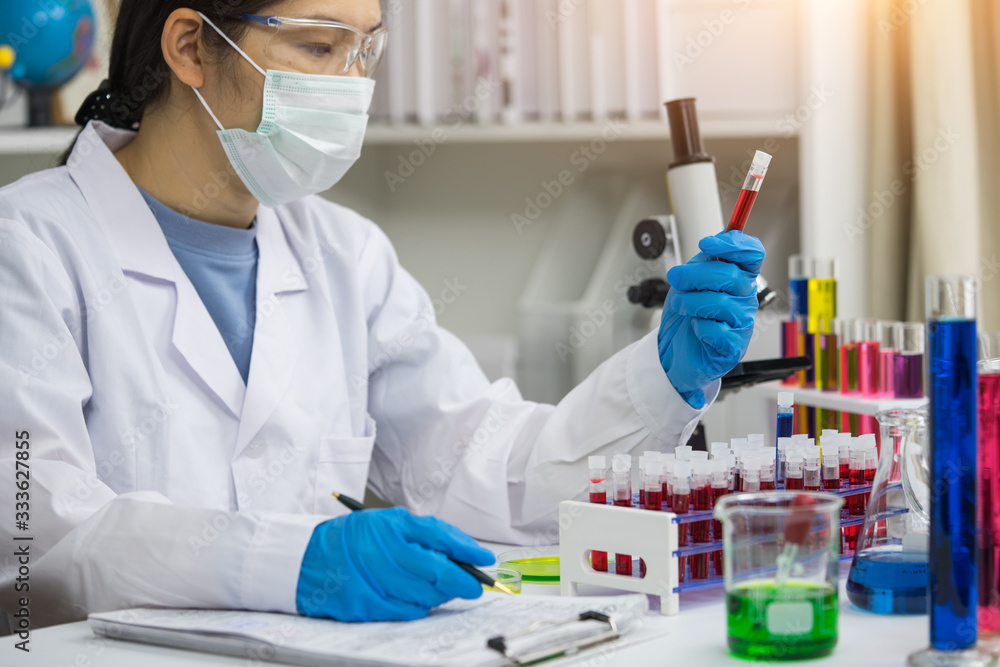 Scientist hand holding test tube with blood in laboratory. Scientist hand holding test tube with blood in laboratory.