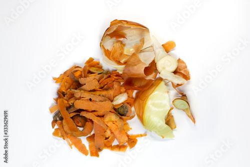 Food waste carrot, onion on a white background. Isolate. Top view. Flat lay. Waste for recycling. Responsible disposal of household food wastage in an environmentally friendly way by recycling.