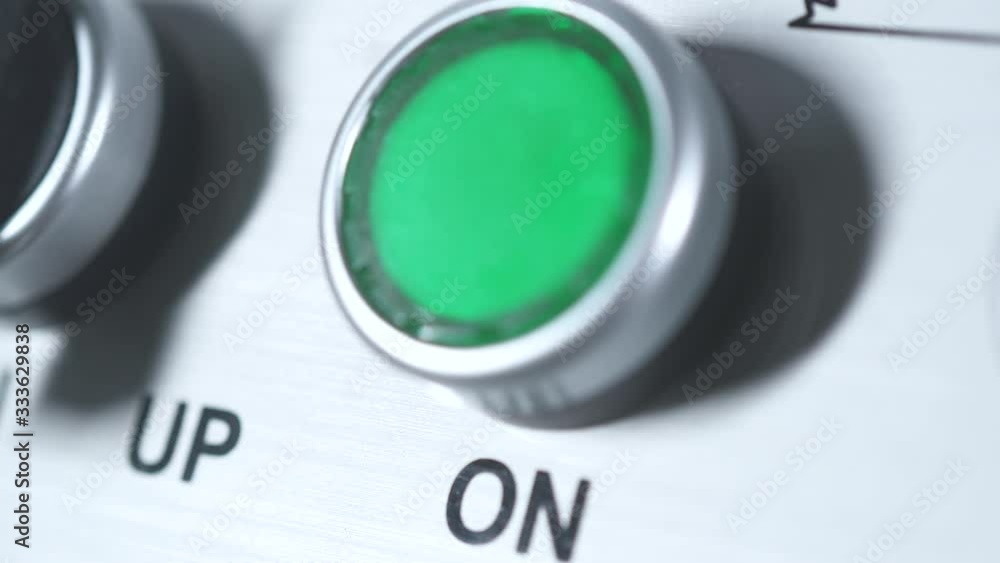 Green button power on. Finger pushing button. Start engine electrical ...