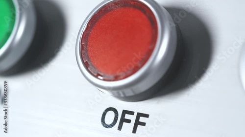 Red button power off. Finger pushing button. Shutdown engine electrical equipment in industrial factory. Panel with red plastic round pressbutton. End of work. Switch off. Turn off the electricity.