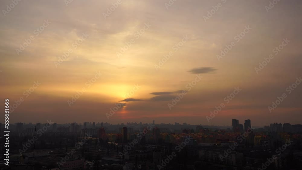 Dove flies close to camera with Kiev cityscape and dramatic sunset with spectacular cloudscape on background Dove flies close to camera with Kiev cityscape and dramatic sunset with spectacular cloudscape on background