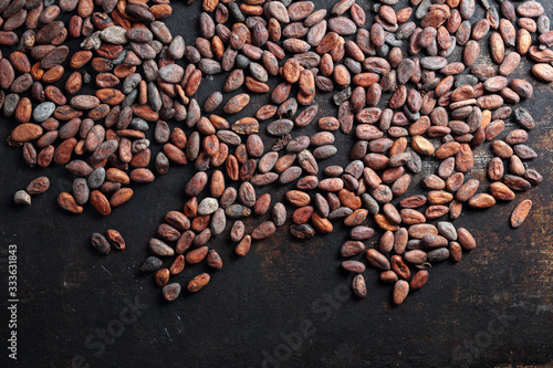 Cocoa Beans. Organic cocoa beans on a dark background. Background with cocoa beans.