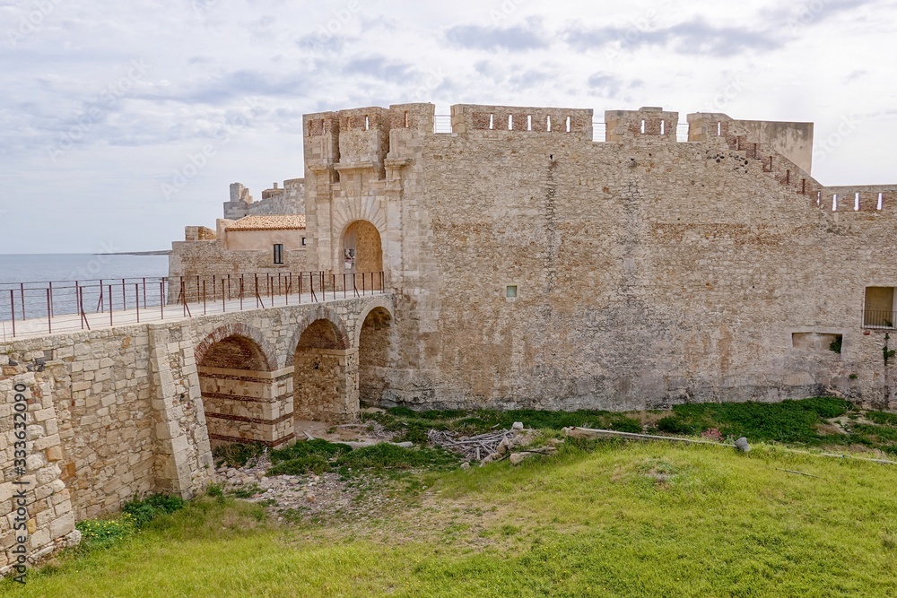 The bridge and Castello Maniace citadel in Siracusa, Sicily, Italy in sunny day