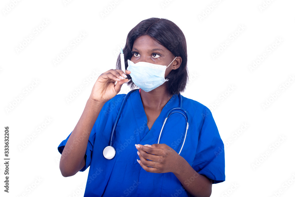 beautiful young female doctor in uniform holding a syringe in hand.