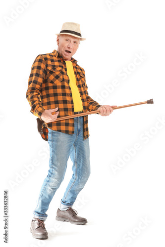 Portrait of happy elderly man with walking stick on white background