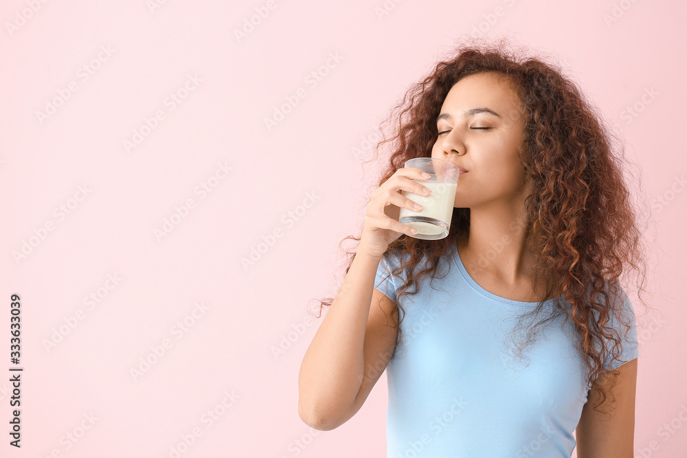 African-American woman with milk on color background African-American woman with milk on color background