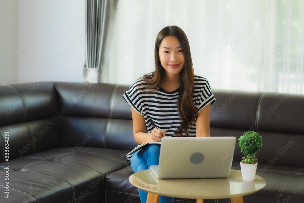 Portrait beautiful young asian woman using laptop or computer noterbook on sofa with concept work from home Portrait beautiful young asian woman using laptop or computer noterbook on sofa with concept work from home