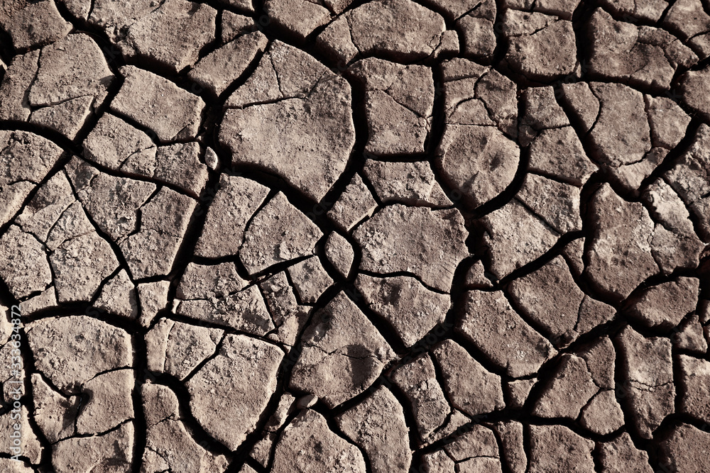 Dry cracked earth background in arid season. Many Province of North East in Thailand the ground dry. Brown cracked soil in the summer When water in Mekong, canal, brook, reservoir, dry up. Dryness. Dry cracked earth background in arid season. Many Province of North East in Thailand the ground dry. Brown cracked soil in the summer When water in Mekong, canal, brook, reservoir, dry up. Dryness.