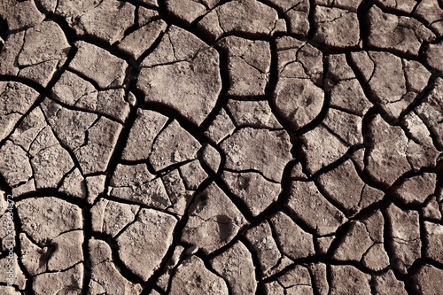 Dry cracked earth background in arid season. Many Province of North East in Thailand the ground dry. Brown cracked soil in the summer When water in Mekong, canal, brook, reservoir, dry up. Dryness.