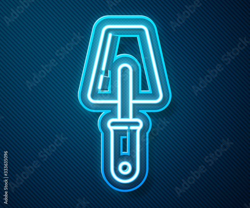 Glowing neon line Trowel icon isolated on blue background. Vector Illustration
