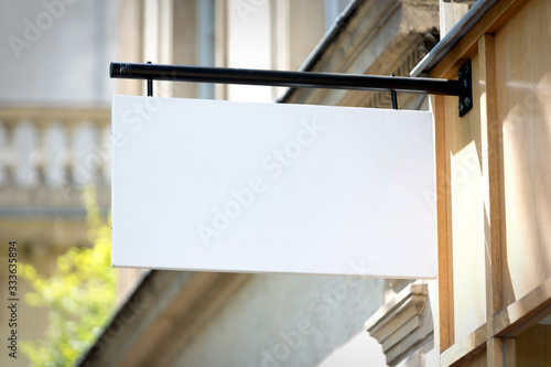 Blank sign board on a shop wall photo