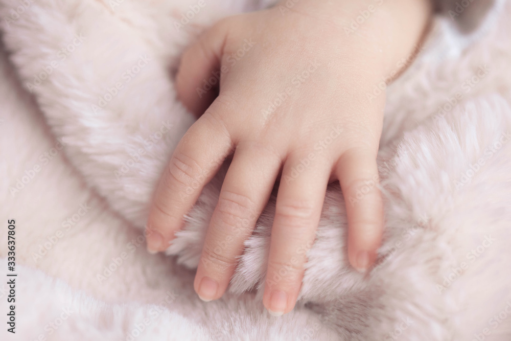 little newborn baby hand on the fluffy blanket little newborn baby hand on the fluffy blanket