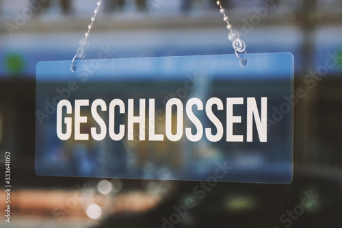 sign geschlossen - closed in german - economy crisis or business closure concept photo