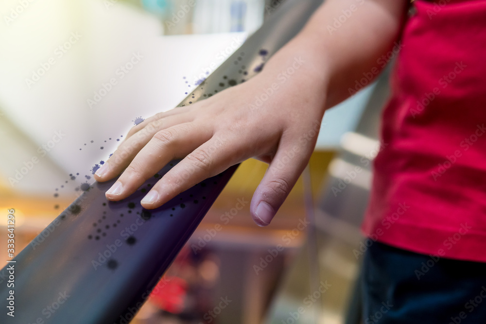 A boy is catching a escalator in an mall with a virus or bacteria. A boy is catching a escalator in an mall with a virus or bacteria.