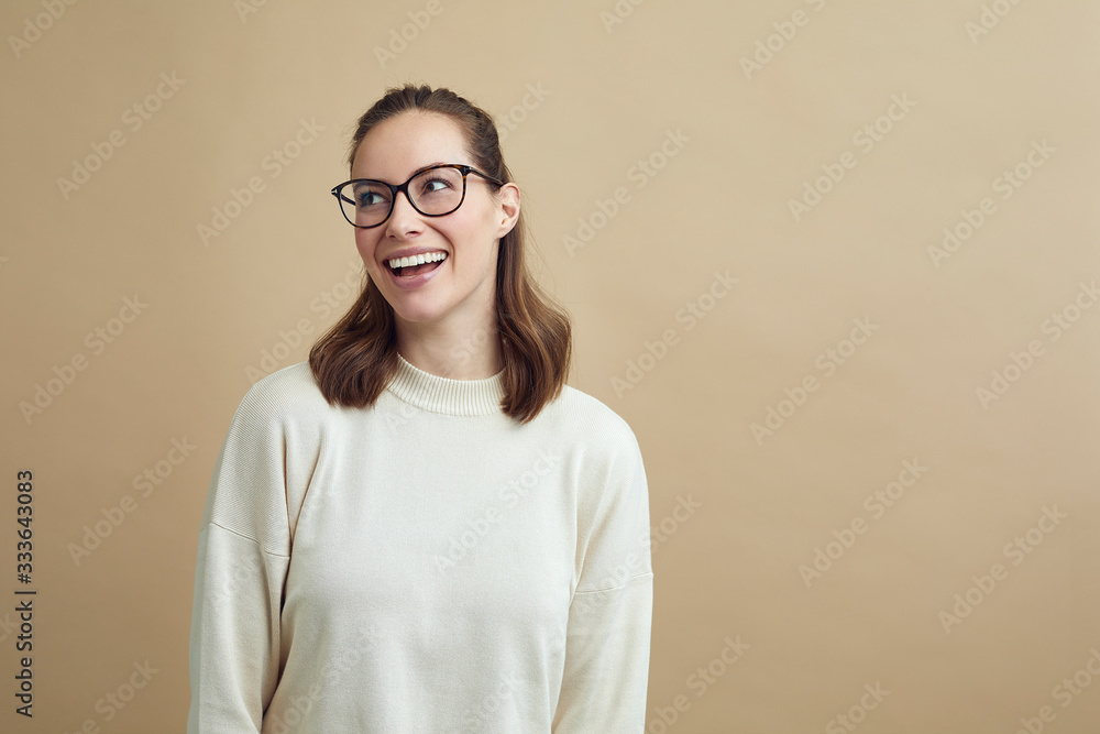 Beautiful smiling adult woman with glasses looking to the side 