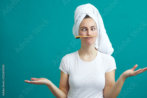 Obraz na plátne Beautiful young woman fooling around with a toothbrush on a colorful background