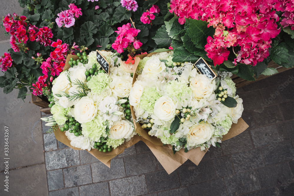 A small business for selling flowers. Blue and pink hydrangeas, white flowers in a street store. Top view.