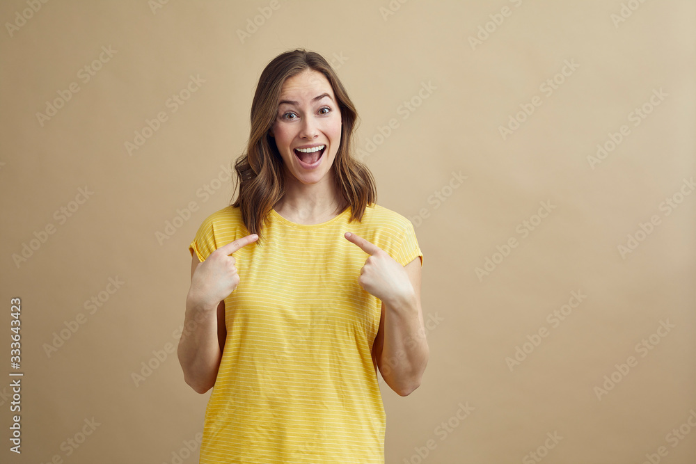 Excided girl pointing at her self, happy that she was chosen Excided girl pointing at her self, happy that she was chosen
