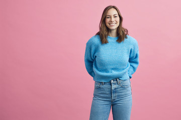Portrait for beautiful smiling woman on a pink background, colorful portrait