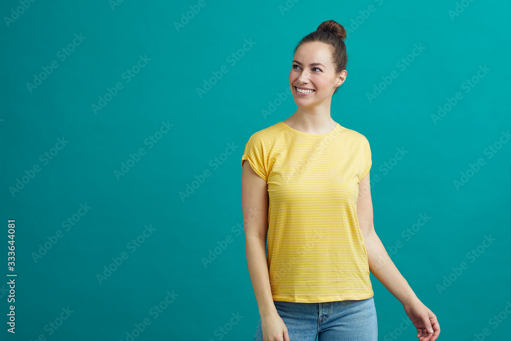 Portrait of young woman in a yellow shirt looking at the copy space Portrait of young woman in a yellow shirt looking at the copy space