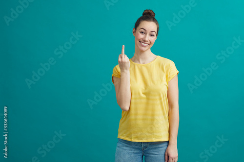 Flippant young woman is crossing her finger and hoping that its going her way photo