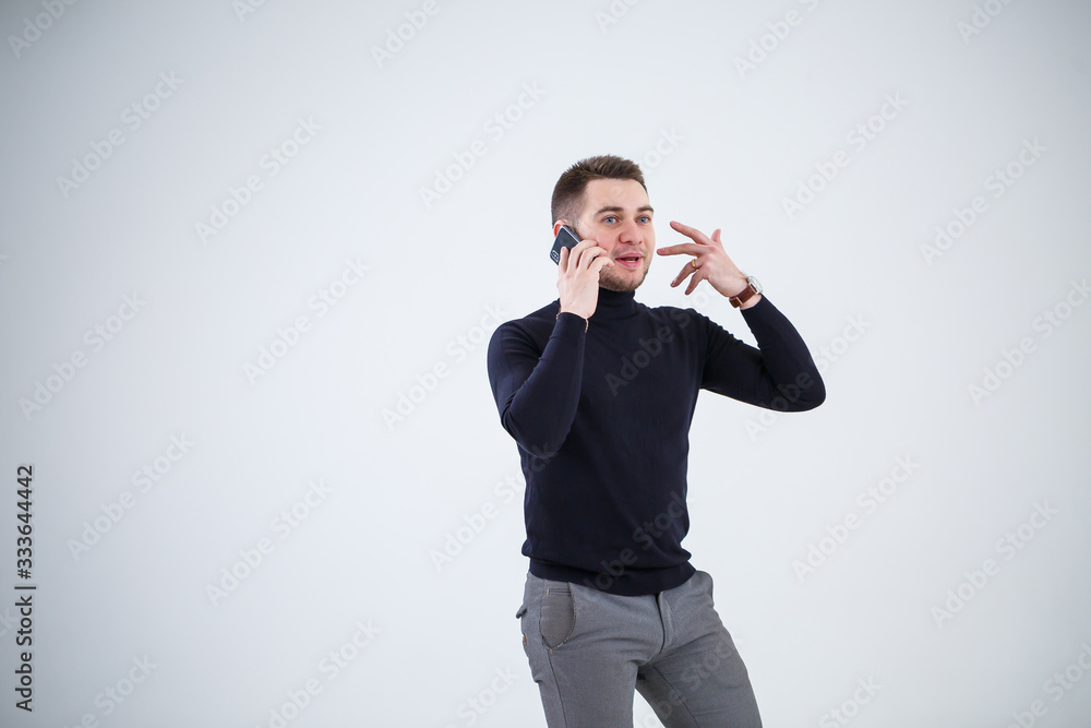 Serious guy businessman in black clothes finds out important questions by phone. Working day concept Serious guy businessman in black clothes finds out important questions by phone. Working day concept