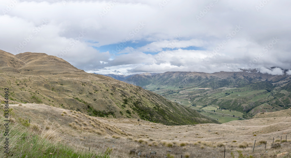 slopes of deep valley with red Tussock grass, near Roaring Meg, Otago, New Zealand slopes of deep valley with red Tussock grass, near Roaring Meg, Otago, New Zealand