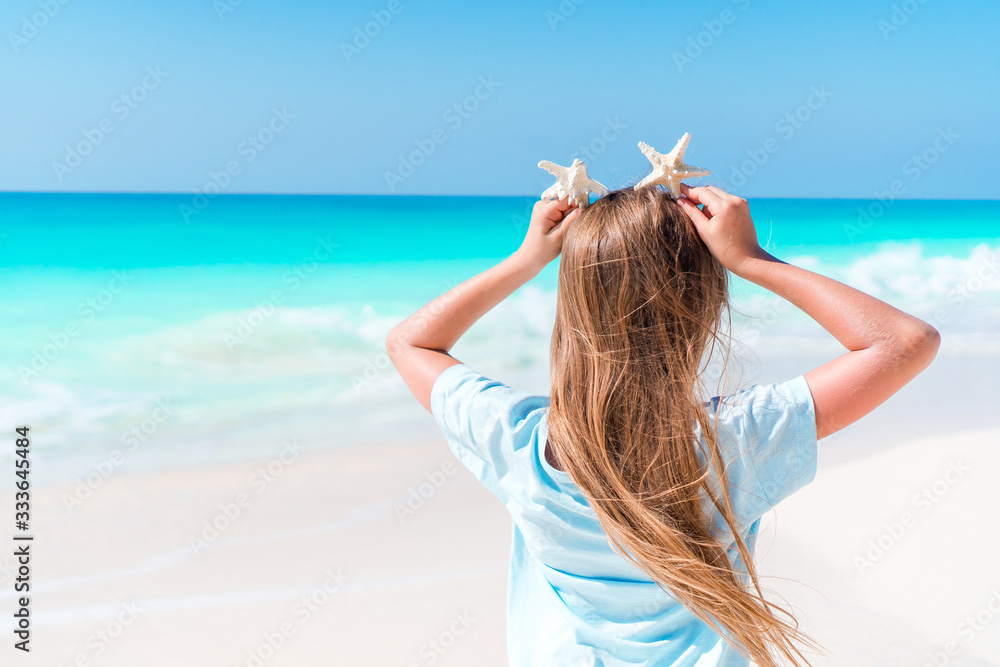 Adorable little girl have fun at tropical beach during vacation Adorable little girl have fun at tropical beach during vacation
