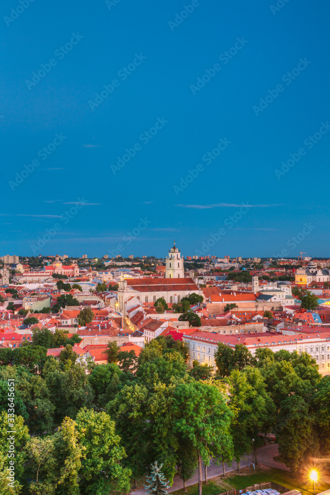 Vilnius, Lithuania. Night View Of Bell Tower And Church Of St. Johns, St. John The Baptist And St. John The Apostle And Evangelist In Old Town