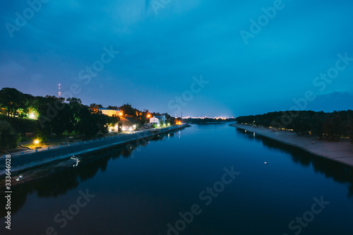 Gomel, Belarus. Night View Of Sozh River, Sand Beach, Lighted Embankment In Gomel, Homiel, Belarus. Summer Evening Night Blue Sky
