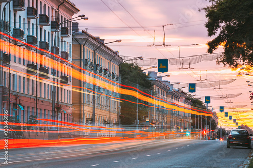 Gomel, Belarus. Traffic And Light Trails On Lenin Avenue In Eveining Or NIght. Street At Night At Long Exposure photo